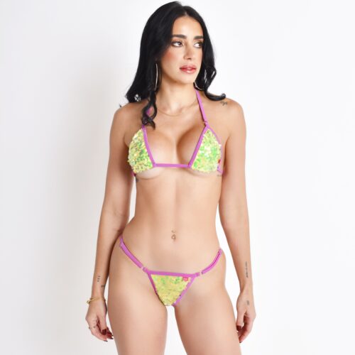 Brunette Female Model Showcasing the Mystic Neon Yellow Sequin Micro Bikini with Violet Straps standing in front of a light grey background.