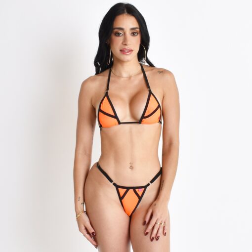 Model showcasing the Orange Crush Sheer Bikini while posing in front of a light-grey background