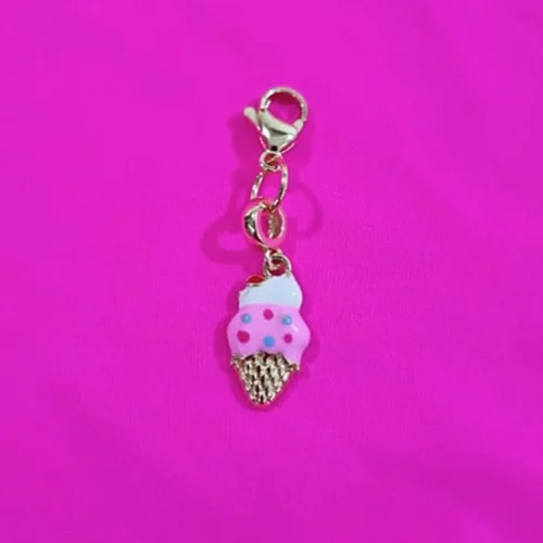 Pink ice-cream pendant charm close-up on fuchsia fabric; accessory detail for the Gelato Fuchsia Micro Bikini