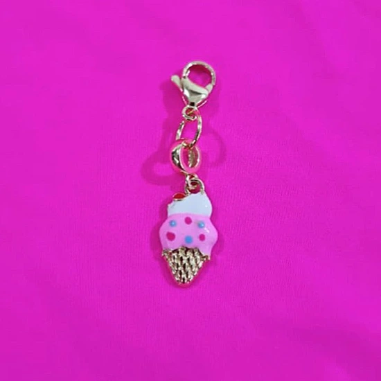 Pink ice-cream pendant charm close-up on fuchsia fabric; accessory detail for the Gelato Fuchsia Micro Bikini