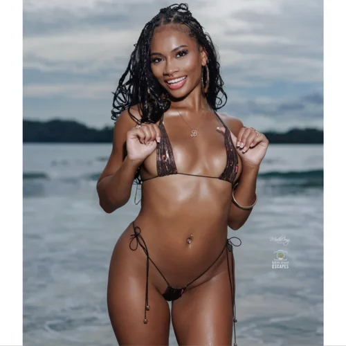Full frontal smiling pose of Mirage Bronze Iridescent Micro Bikini with model adjusting triangle straps
